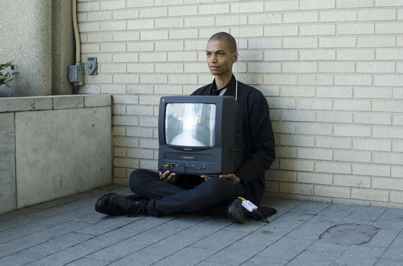 person sitting on floor holding a television