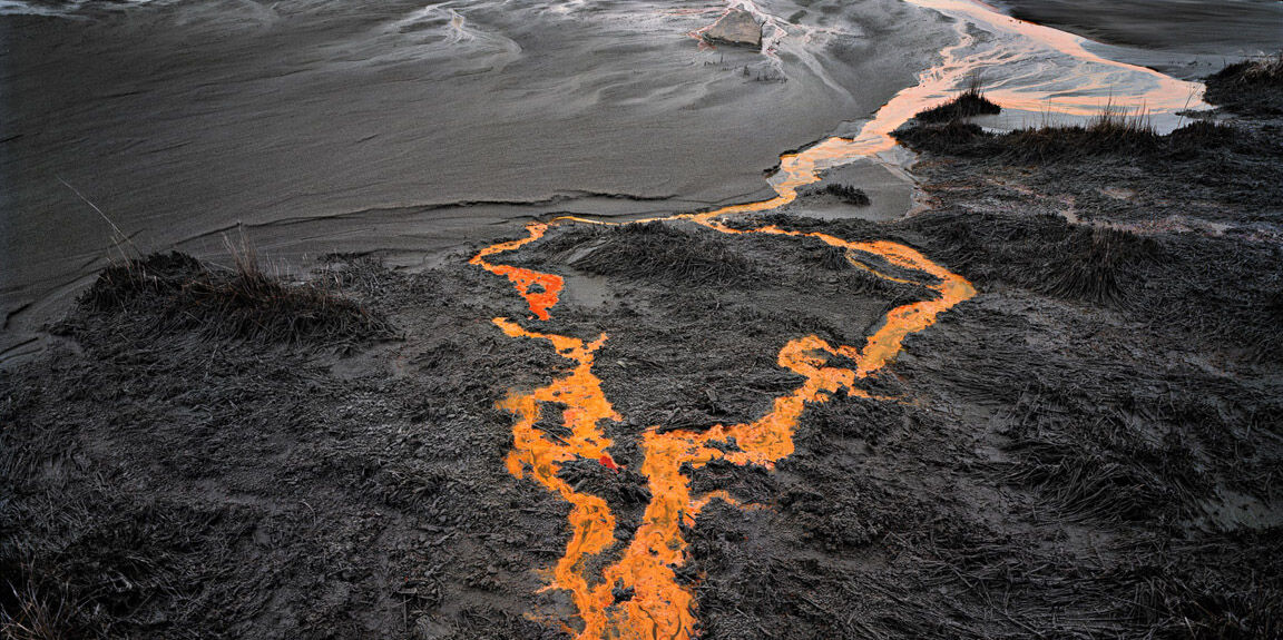 Image of black and white landscape with orange liquid