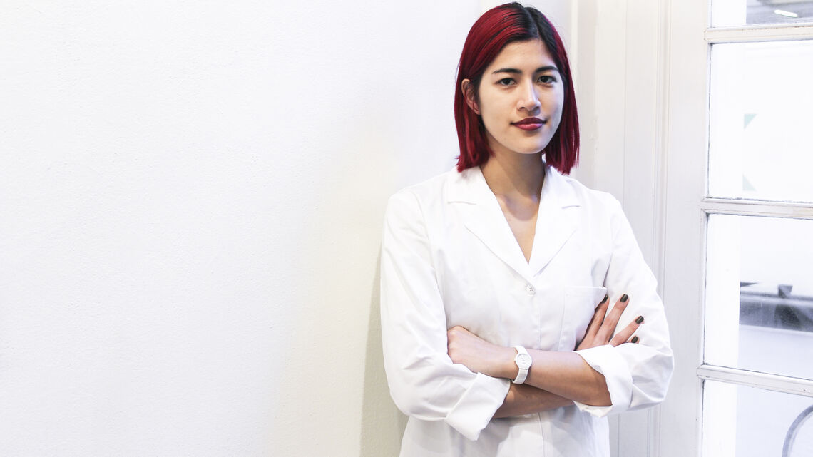 Image of woman with red hair in white lab coat