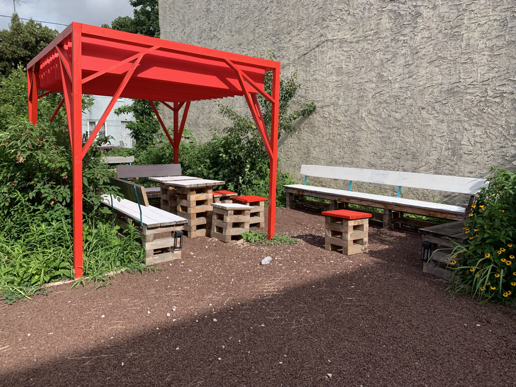 the pocket park after the youth ambassador program, showing a new pergola and seating in a lush garden