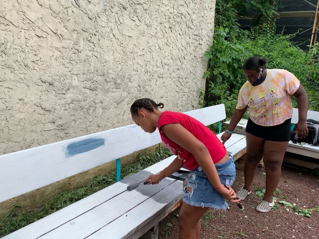 young people painting benches