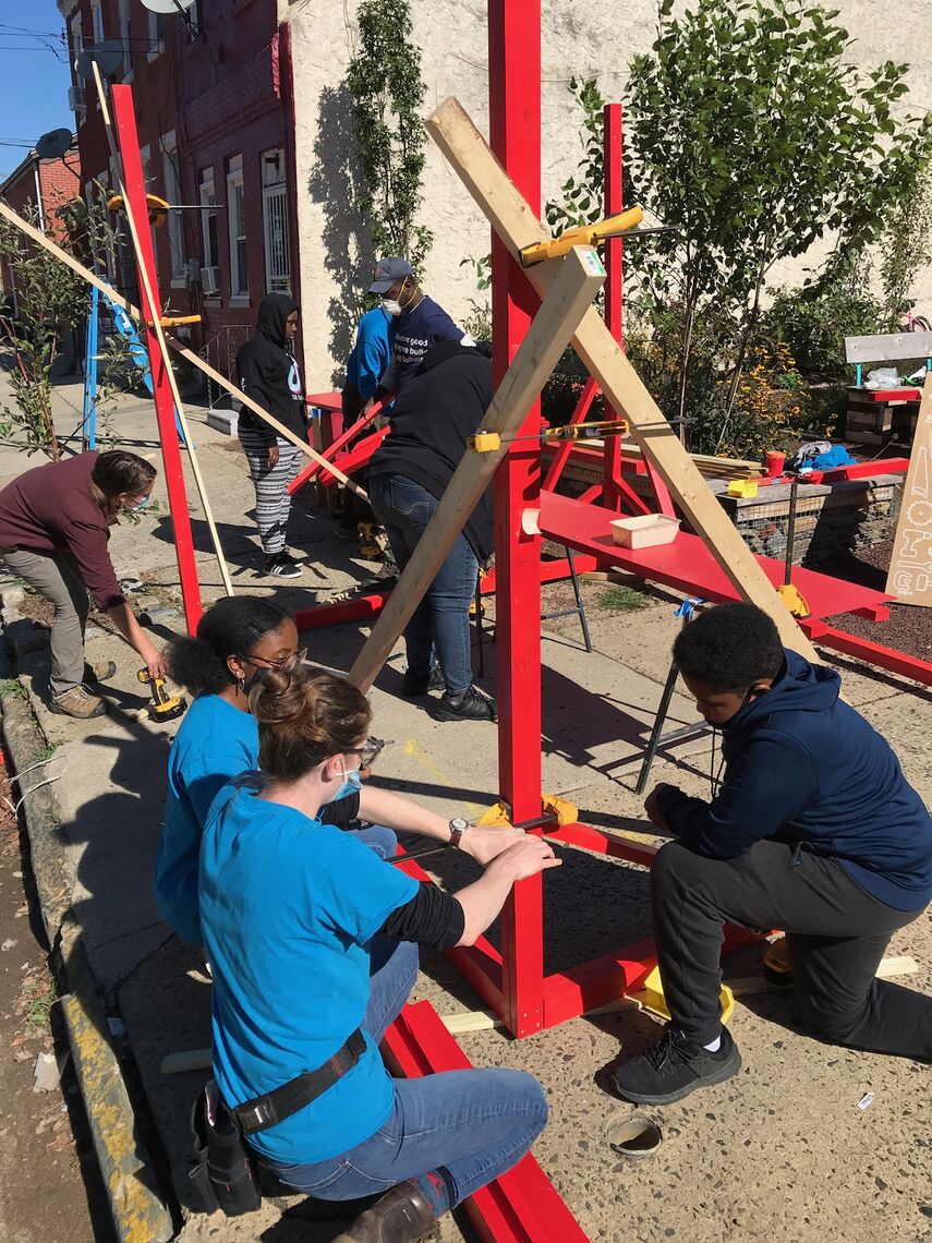 young people building a pergola for the park