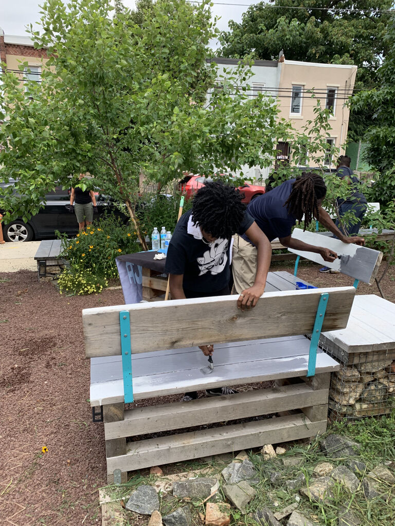 young people painting benches