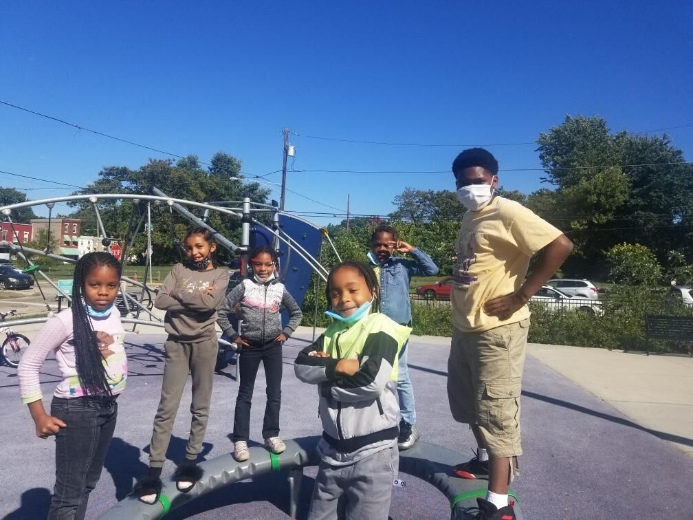 a group of children posing in a park