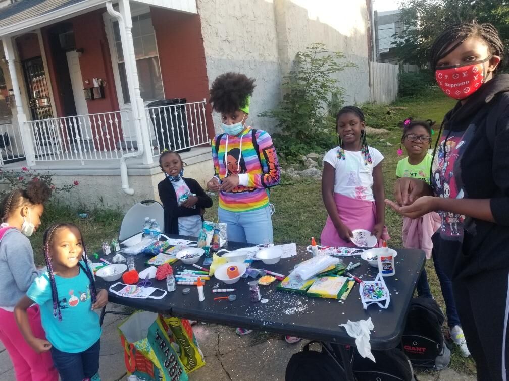 a group of children doing crafts outdoors