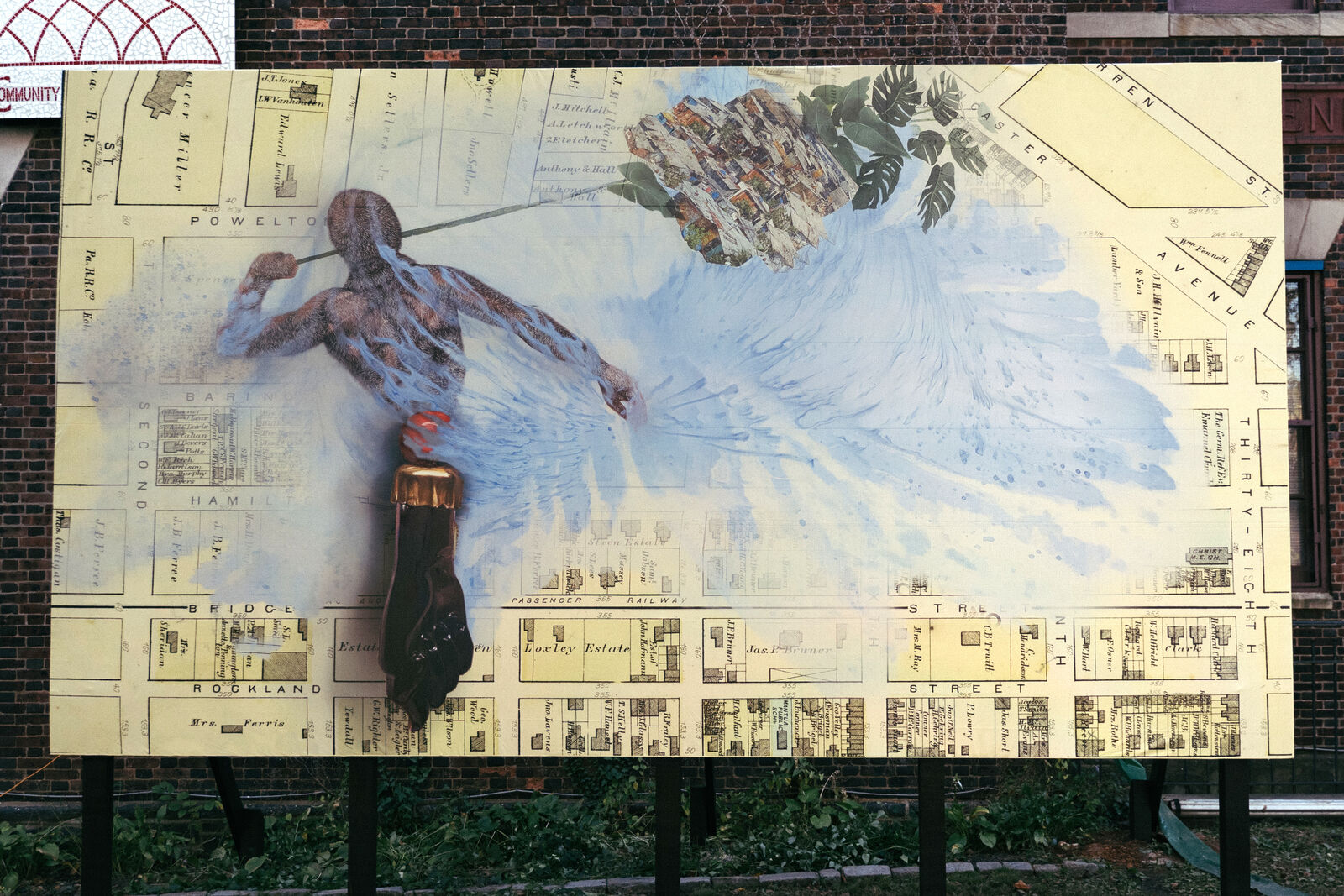 a mural showing a figure with large wings sculpted and painted on a city plan