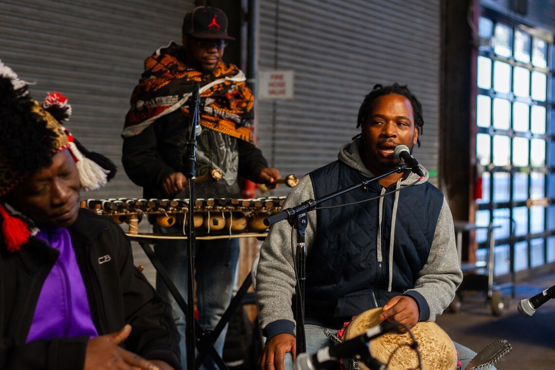 Festival for the People - Day of Movement. A shot of 3 people singing and playing instruments.