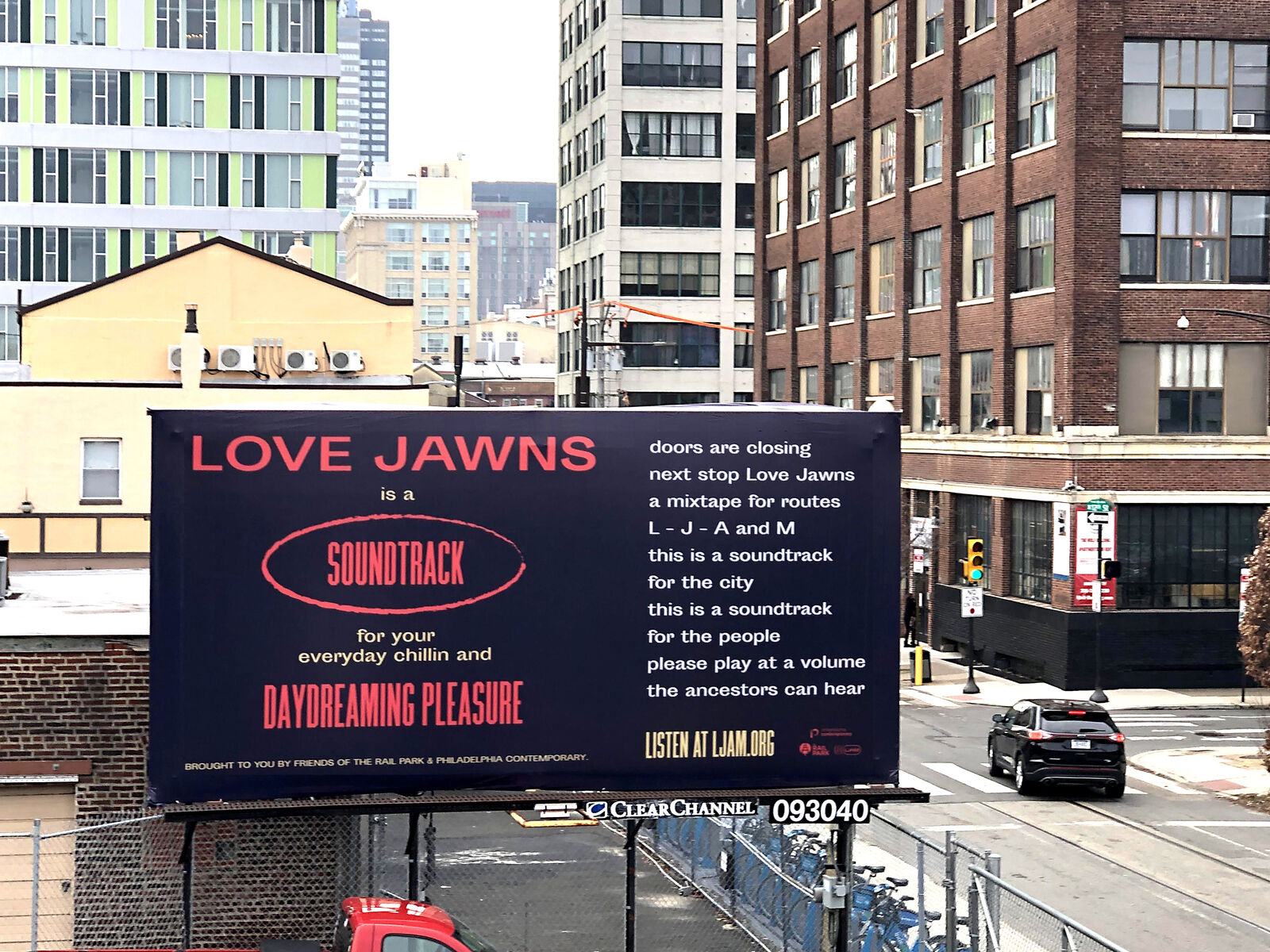 Billboard that says "love jawns is a soundtrack for everyday chillin and daydreaming pleasure" with a poem verse beside it