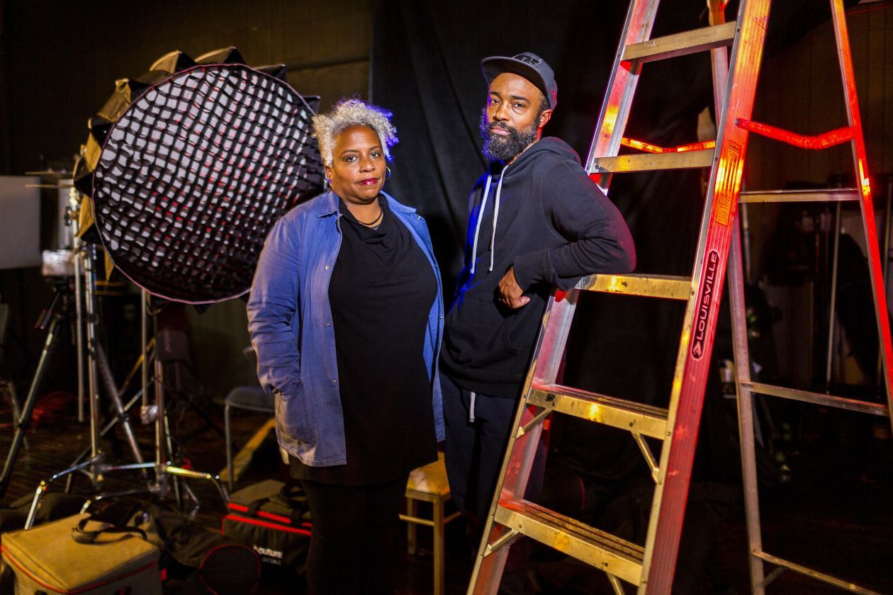 woman and man stand next to a ladder